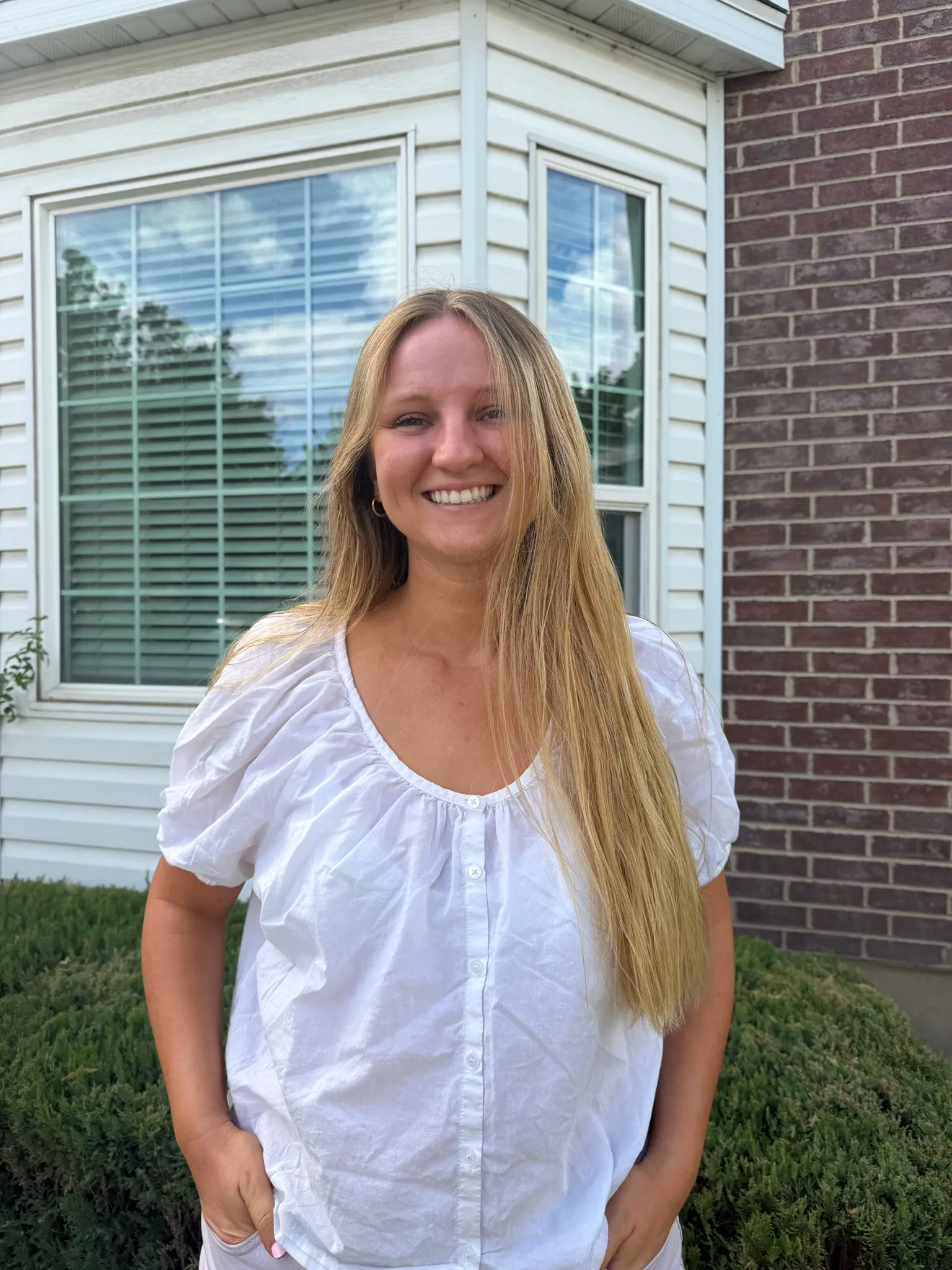 Smiling Cocoa Kissed client outdoors with a natural, sun-kissed spray tan