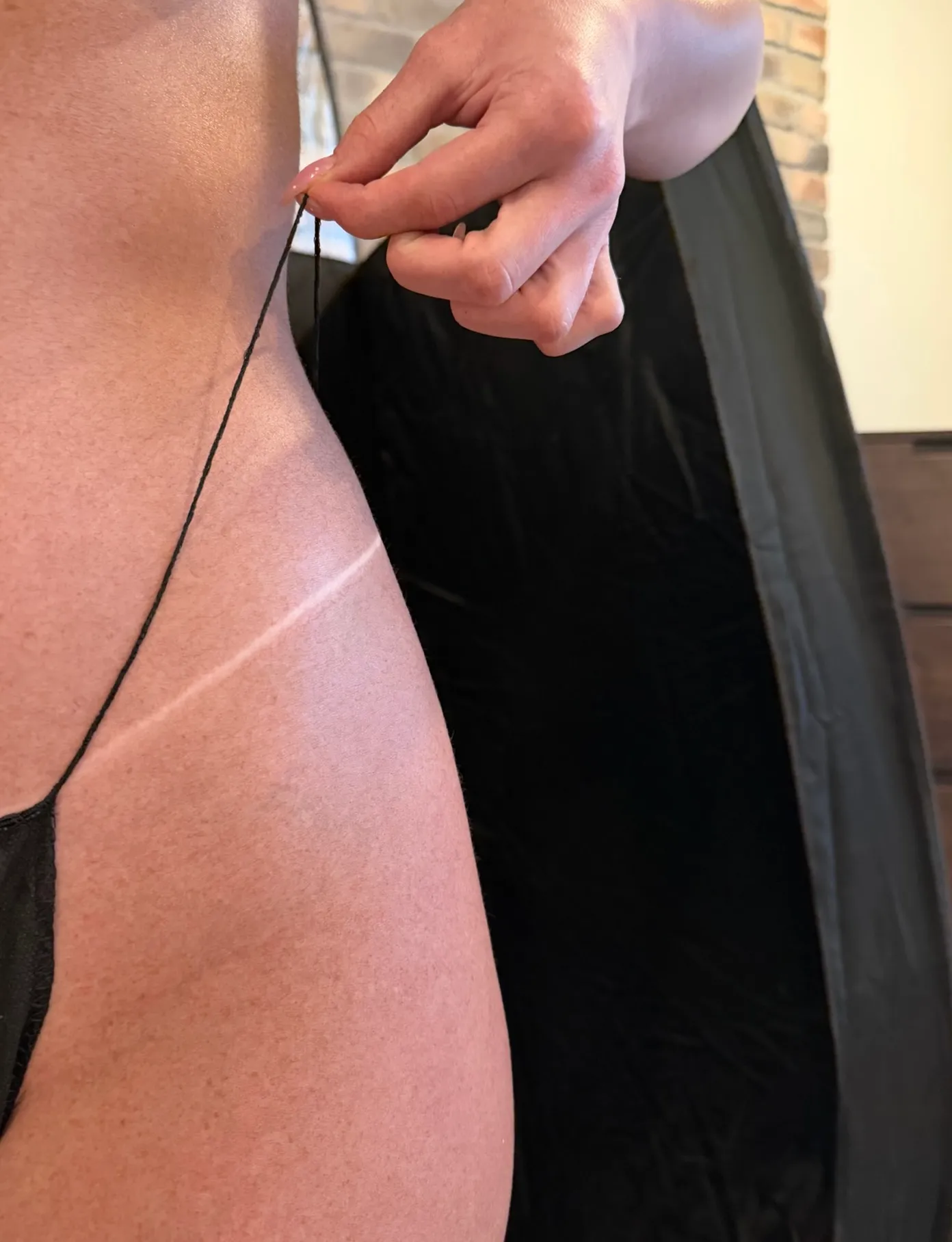 Close-up of an even, natural-looking spray tan with a crisp tan line